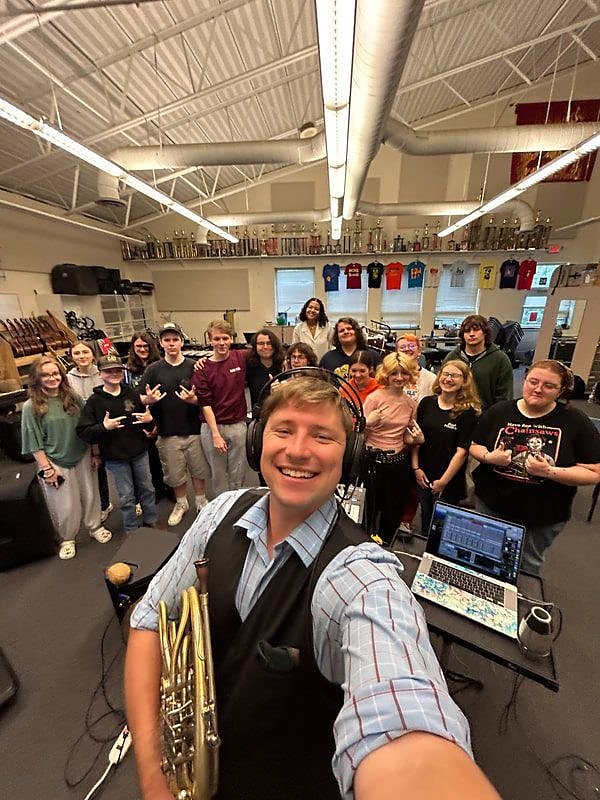 Brian KM with a group of high school students after a performance
