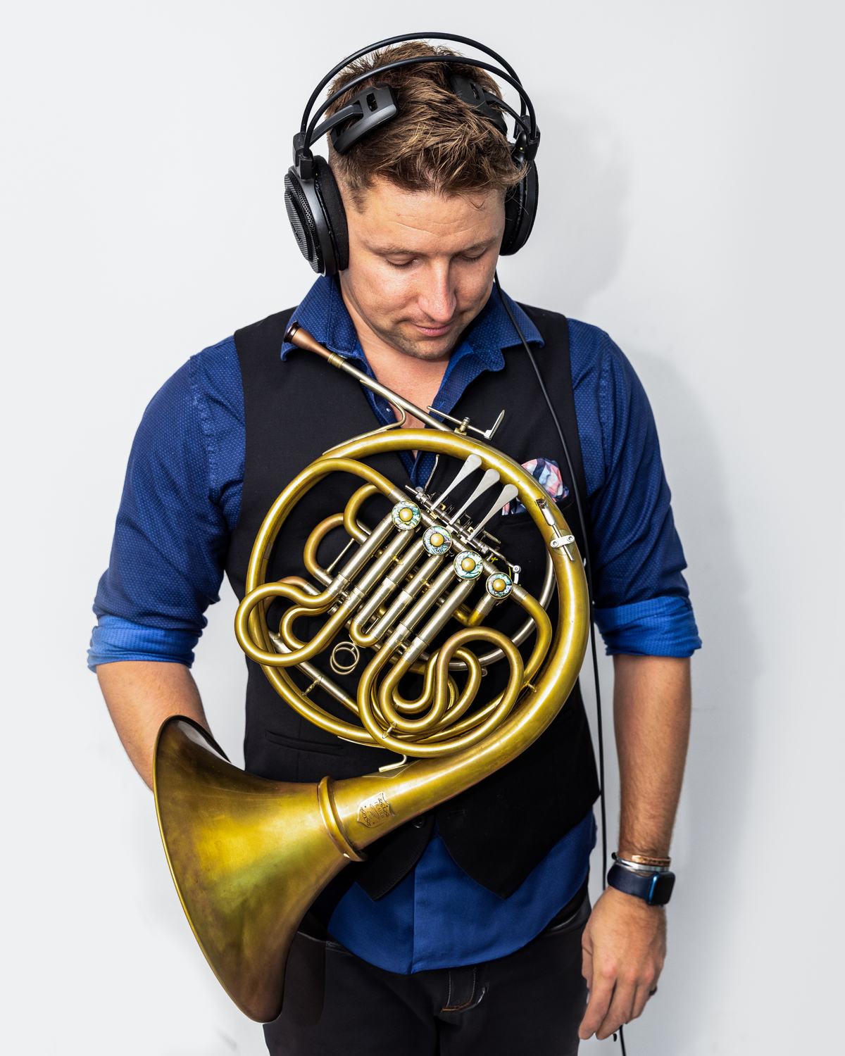 Brian KM with his horn and studio headphones